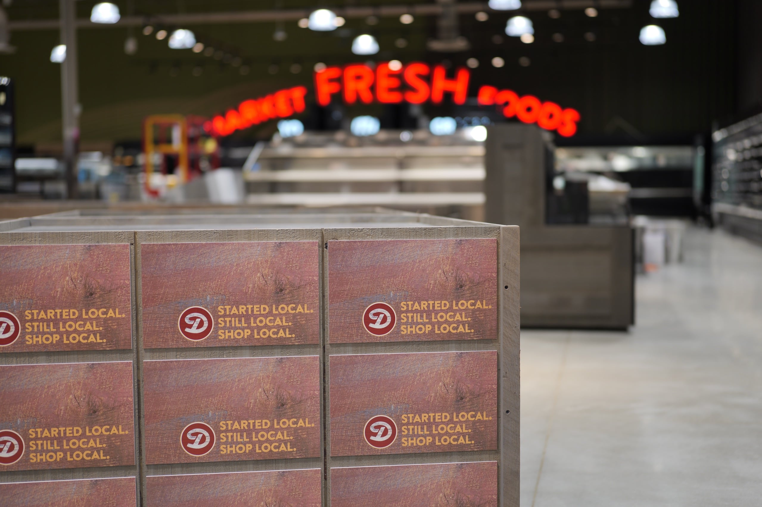 An image inside the Market at 370 store with "Started Local. Still Local. Shop Local." signage.
