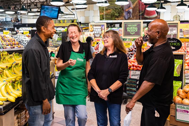 Various Dierbergs Associates standing together and talking in a store.